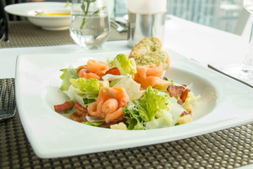  delicious salmon with vegetables salad on plate