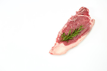 Raw steak with spice on white