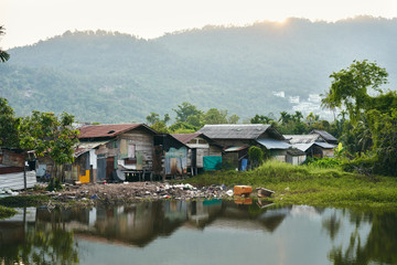 Fototapeta na wymiar Slum houses on the river in Thailand