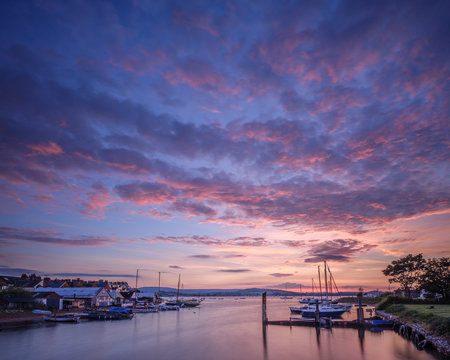 Sunset with boats on the Exe shoreline at the back of Camperdown Terrace, Exmouth, Devon