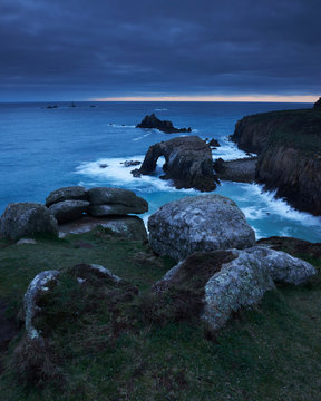 Sunset at Land's End over Enys Dodman rock arch, Longships Lighthouse, Cornwall