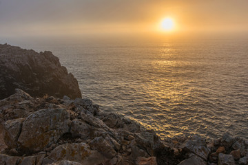 Fototapeta premium Sunset at the cape of San Vicente (in Portuguese Cabo de São Vicente) located in the southwestern tip of Portugal. It is located near Sagres (Portugal)