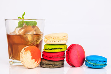 Colorful macarons cakes with and cup tea Isolated