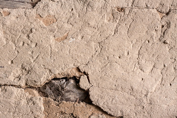 Old cob wall with cracked surface