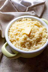 Couscous with butter in pot