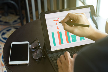 businessman using  drawing comment in tablet for analysis graph visualization at coffee shop