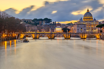 St. Peter's cathedral and Tiber river with high water at evening with dramatic sunset sky. Saint...