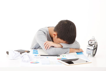Tired and exhausted asian primary school student. Falling asleep while studying. ISOLATED ON WHTIE...