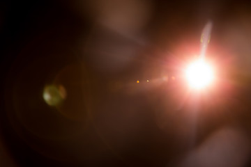 Abstract Natural Sun flare on the black background.