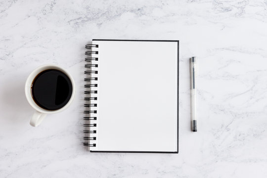 Notepad On Desk With Coffee And Pen