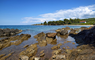 Fototapeta na wymiar Beautiful seascape with stones and translucent blue water