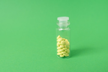 medical pills on isolated green background, concept of life and health