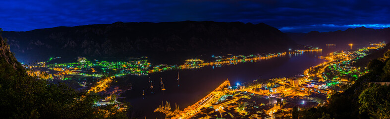 Montenegro, XXL panorama of illuminated houses, streets, harbor and old town of city of kotor bay...