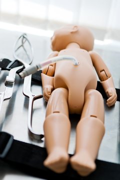 Newborn mannequin and birth tools.