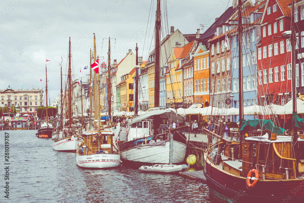 Wall mural Scenic summer view of Nyhavn pier with color buildings, ships, yachts and other boats in the Old Town of Copenhagen, Denmark.