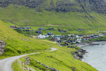 Bour village. Typical grass-roof houses and green mountains. Vagar island, Faroe Islands. Denmark. Europe.