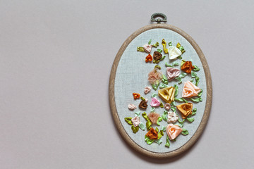 Close up view for the hand embroidery with satin, silk and nylon ribbons of flower ornament with...