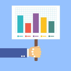 hand holds a table with a graph on a blue background