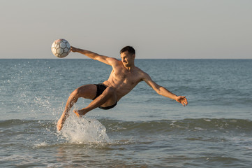 Man playing ball in the sea