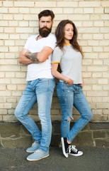 Casual meeting. Casual couple in love. Boyfriend and girlfriend romantic date. Man bearded and girl friends. Couple in love romantic date huddle outdoors brick wall background. Urban youth on date