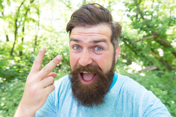 The forks. Man gesturing V sign as insult. Brutal man giving offensive gesture. Vulgar man with...