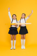 Geometry school lesson. Teamwork concept. Close or far. Measuring skills. Measuring distance. Measuring equipment. Kids students study math. Knowledge day. Schoolgirls school uniform hold big ruler