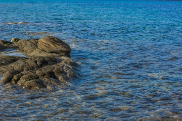 natural peaceful background of stones in lake water surface wallpaper pattern scenic photography with empty space for copy or text