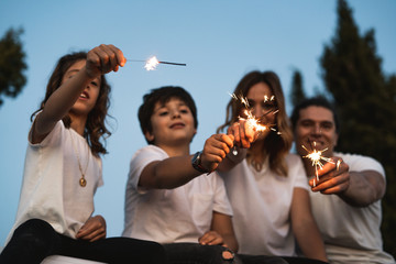 Family with happy sparklers