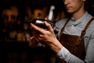 Close-up of the shaker in bartender's hands