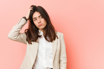 Fototapeta premium Young brunette business woman against a pink background being shocked, she has remembered important meeting.
