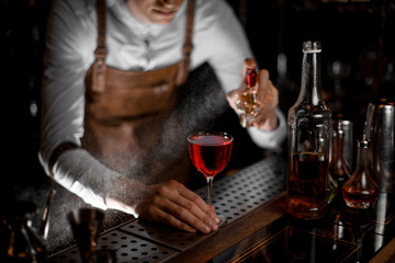 Bartender pouring an alcohol drink with sprayer