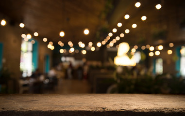 Fototapeta na wymiar Empty wood table top on blur light gold bokeh of cafe restaurant in dark background