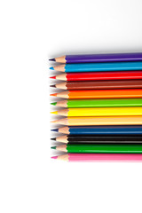 Color pencils lie on a white background