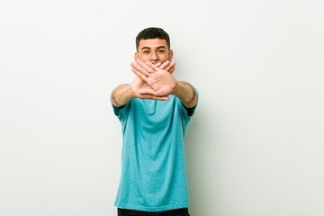 Naklejka premium Young hispanic man doing a denial gesture
