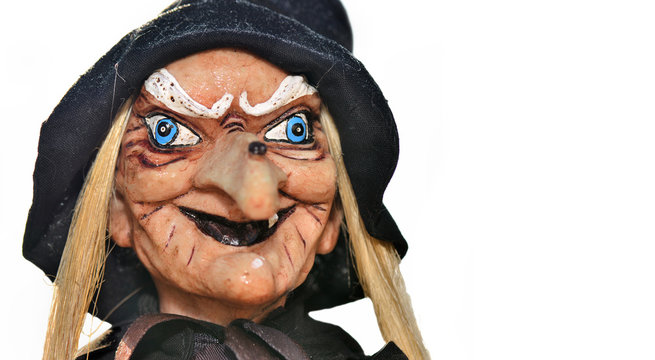 portrait of an ugly witch doll with balck hat on white background