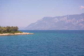 Naklejka premium Aegean Islands on mountains and blue sky background, Turkey. Tropical wallpaper, paradise beach