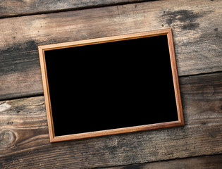 rectangular brown wooden frame on a background of very old boards