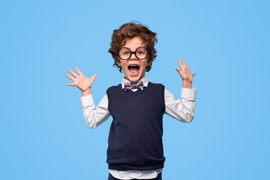 Excited schoolboy screaming and gesturing with hands