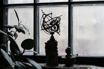 Celestial globe and a kerosene lamp standing on the windowsill