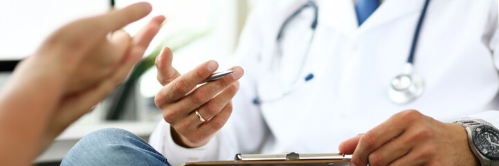 Therapeutist in clinic office receiving sick client