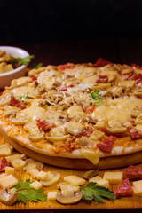 Freshly baked pizza with mushrooms, salami and cheese