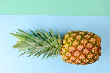 Pineapple on a blue and green background. Copy space.