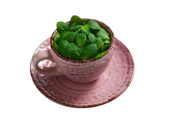 Mint leaves in a cup isolated on white background.
