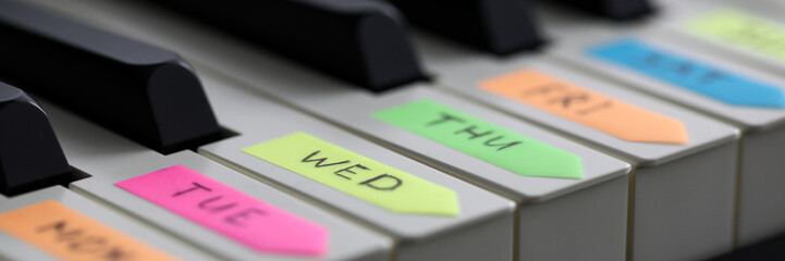 Empty piano keyboard with colourful notes © megaflopp