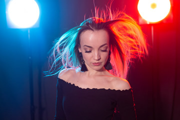 Portrait of young sexy woman with flashes on background