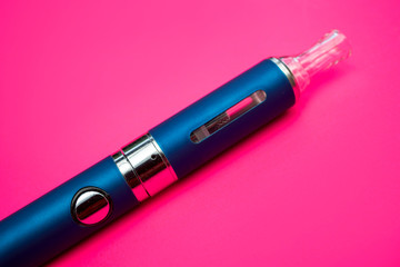 Vape pen metal electronic cigarette with vaping pink background