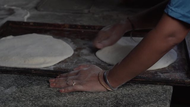 Hands attached dough lid, kneading to seal it
