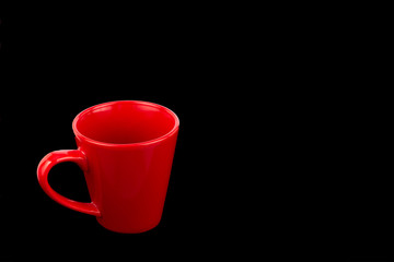 Red cup on a black background. Copy space.Concept of filling capacity, Christmas, design, decoration.