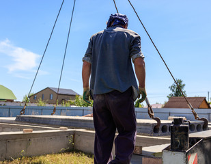 A crane raised a concrete slab at a construction site at home