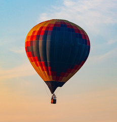 Balloon flying in the sky in the rays of the sunset